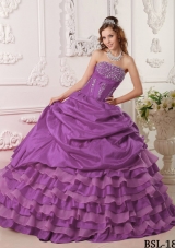 Purple Ball Gown Strapless Quinceanera Dress with Ruffled Layers and Beading